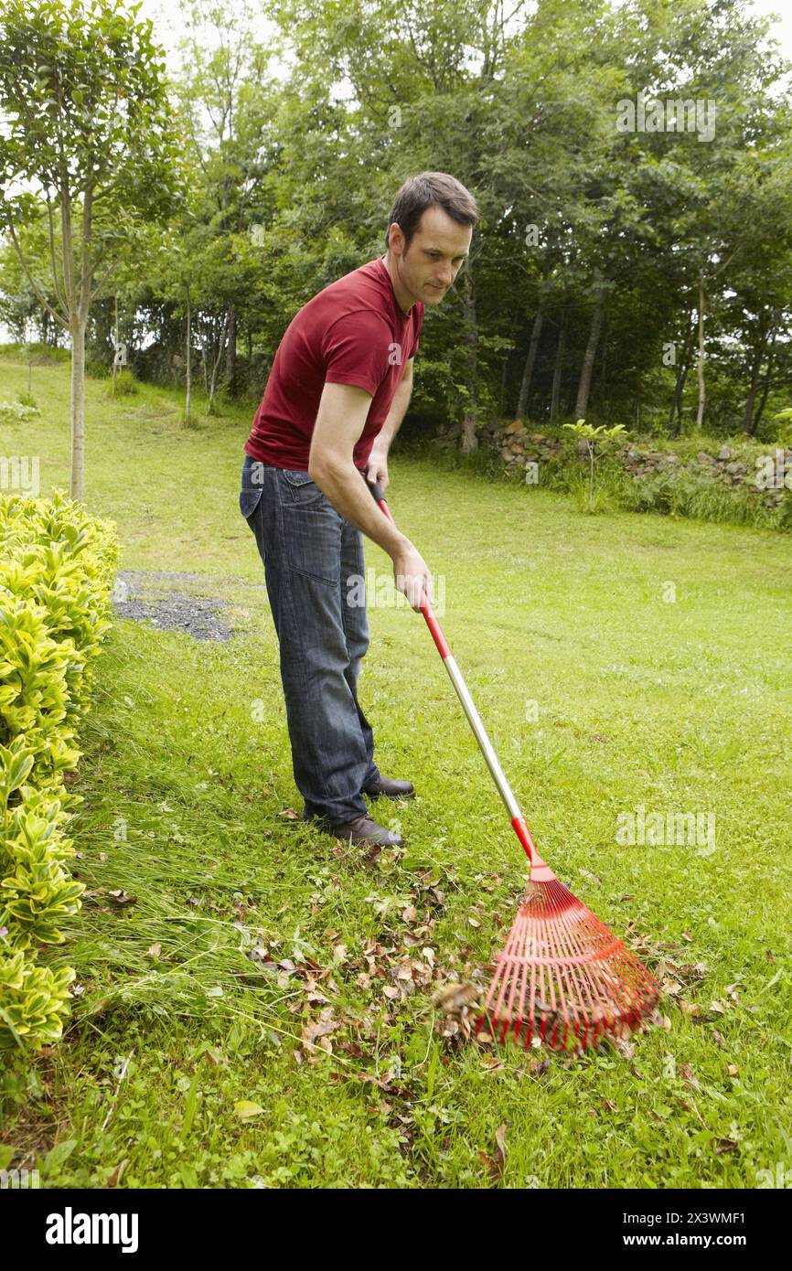 Man using sweep rake hi-res stock photography and images - Alamy