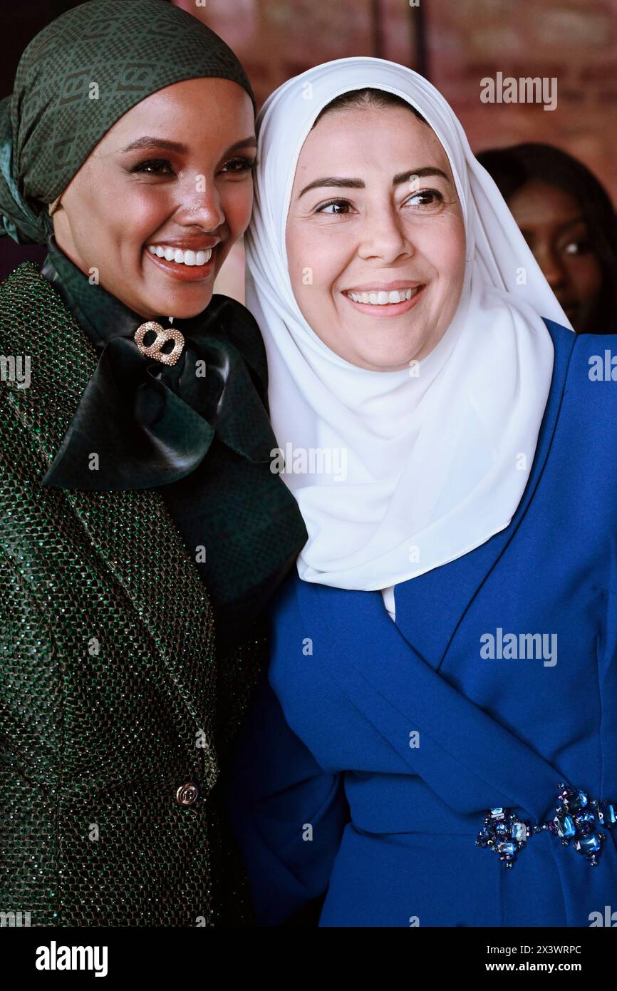 Halima Aden (L) seen taking a picture with a lady. Somali-American ...
