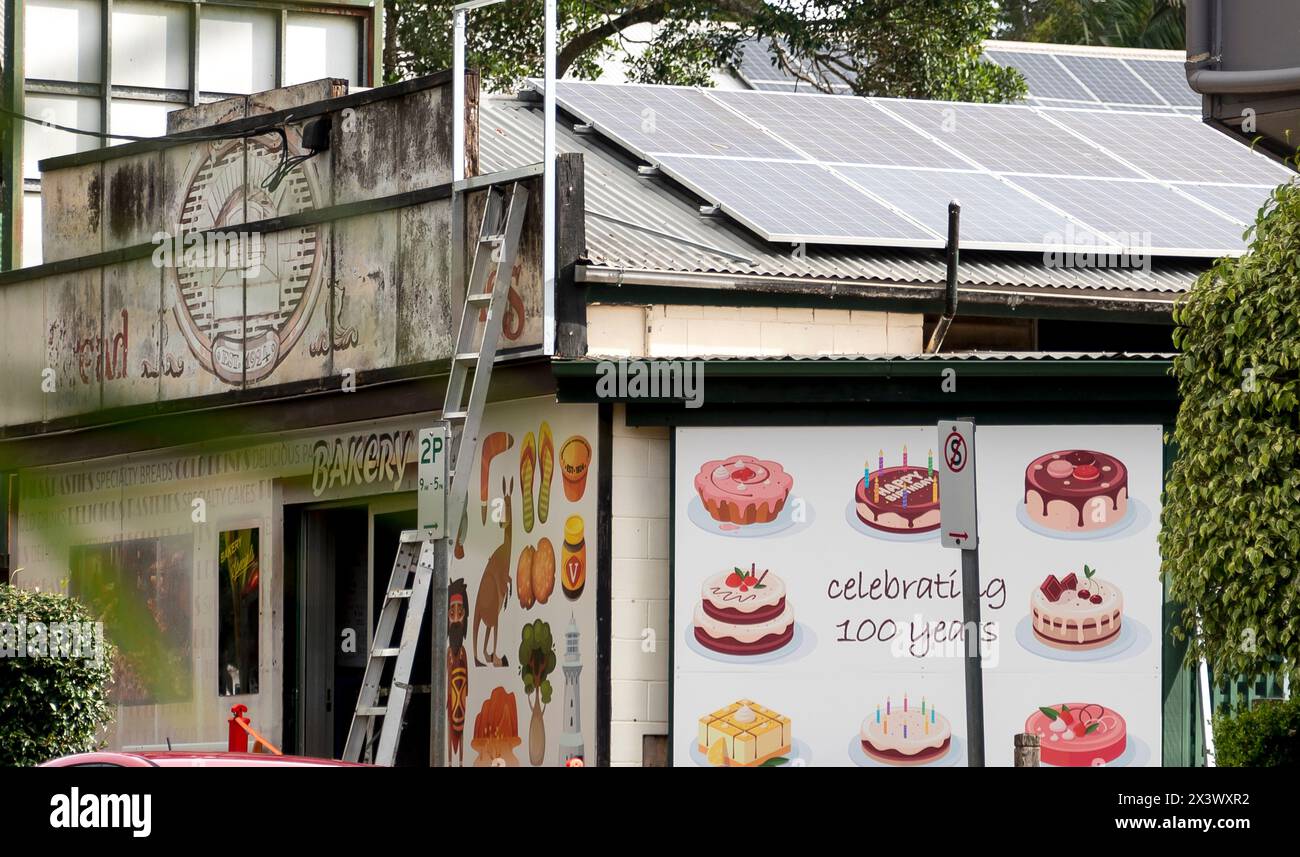 100 year old bakery being repainted in North Tamborine village, Queensland, Australia. Work-in-progress. Cakes and pastries pictured in celebration. Stock Photo