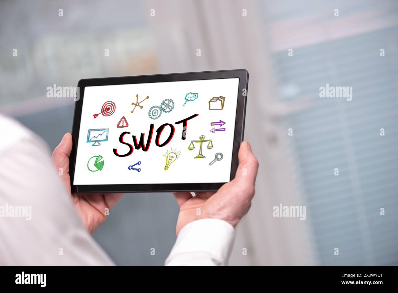 Swot concept shown on a tablet held by a man Stock Photo