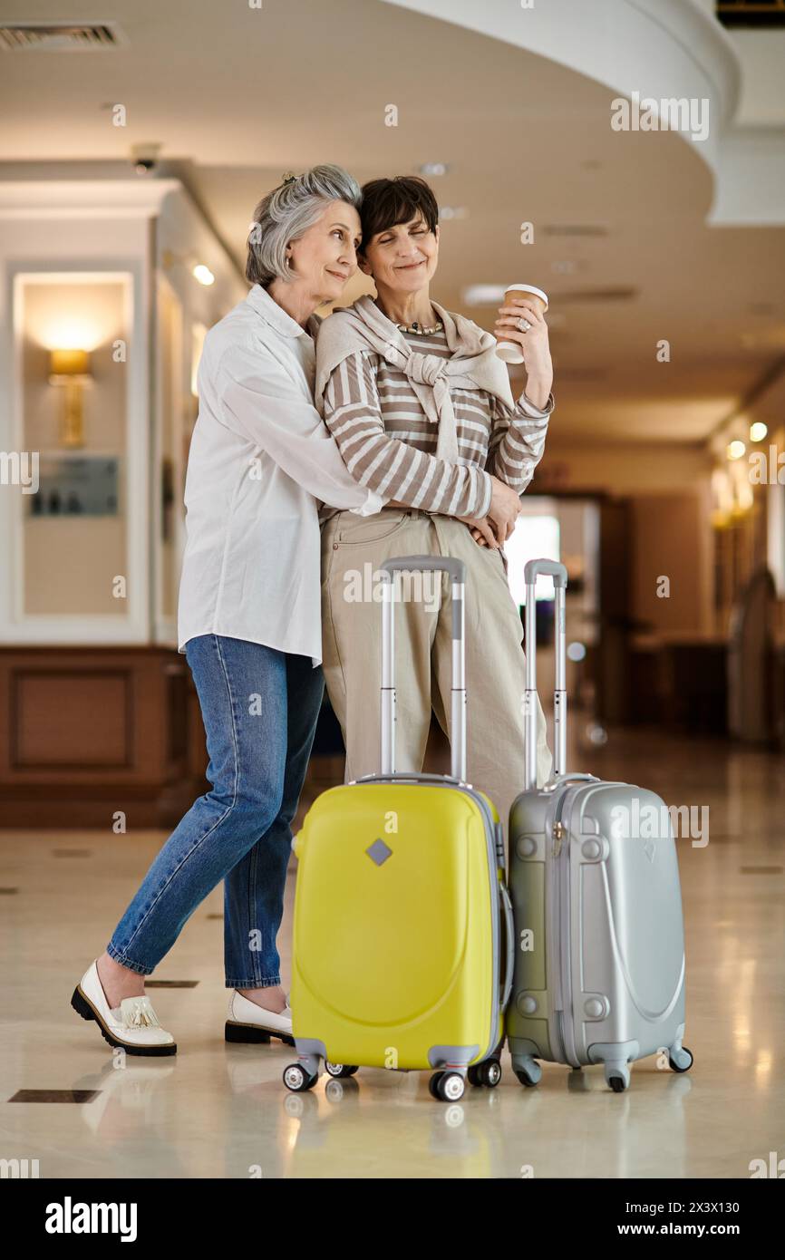 Senior lesbian couple ready for adventure with luggage in hand. Stock Photo