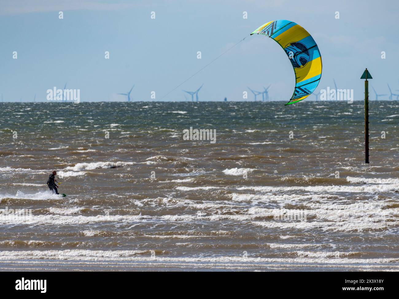 Morecambe, Lancashire, UK. 28th Apr, 2024. A parasurfer enjoying the waves on a windy Sunday in Morecambe Bay, Lancashire, UK. Credit: John Eveson/Alamy Live News Stock Photo
