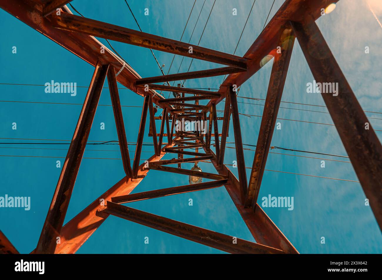 Old worn electricity pylon transmission tower, low angle view Stock Photo