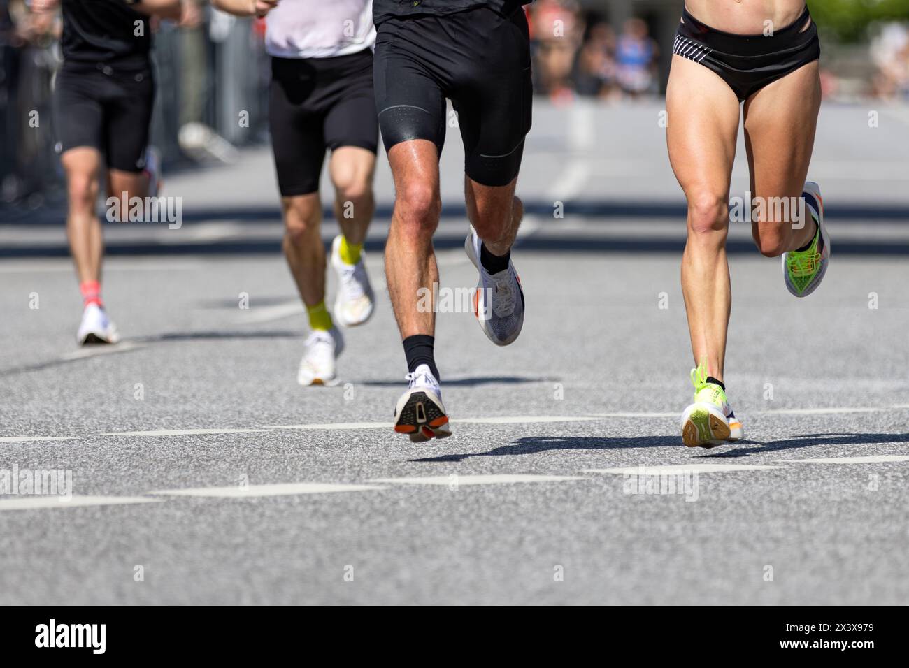 Legs of male and female runners during marathon Stock Photo