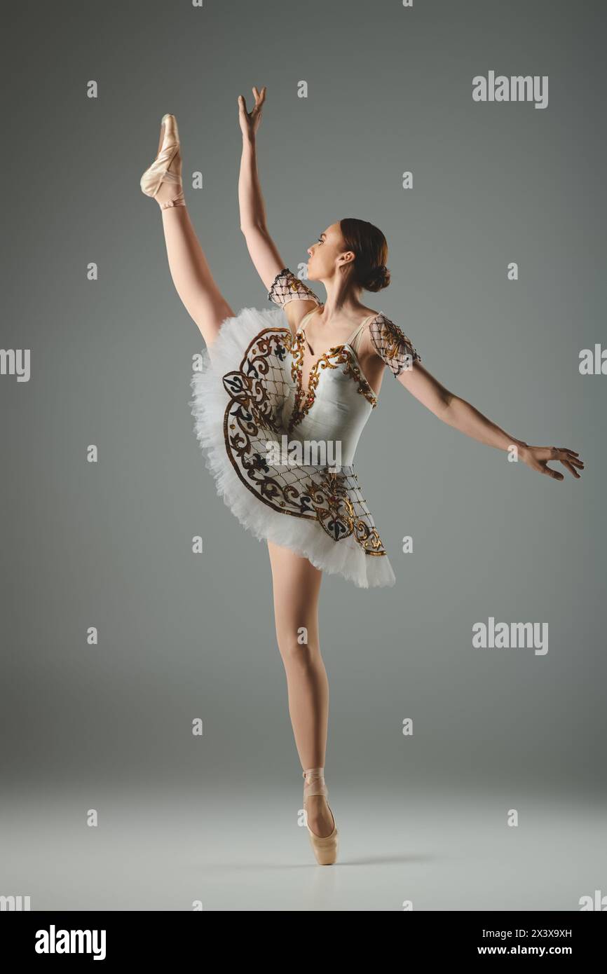 Young, talented ballerina dances gracefully in white tutu and leotard. Stock Photo
