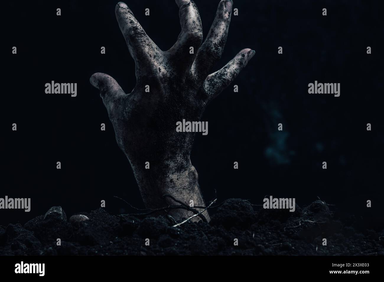 Zombie hand coming out of the ground, halloween concept Stock Photo