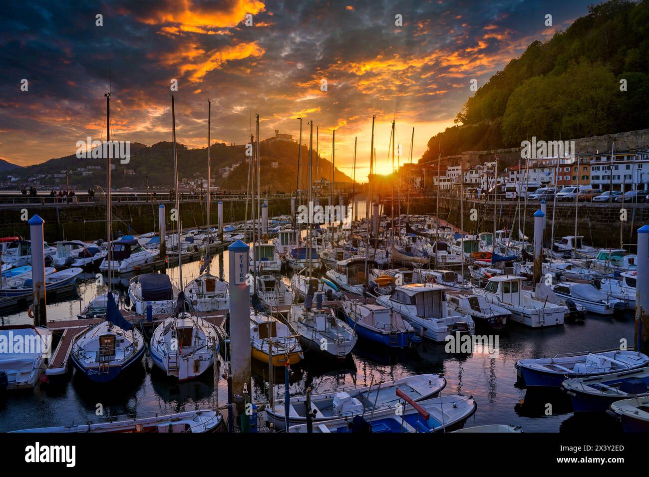 The port of San Sebastian lies at the eastern side of La Concha Bay, below the Sagrado Corazón Statue on Mount Urgull. It is a small triangular port w Stock Photo