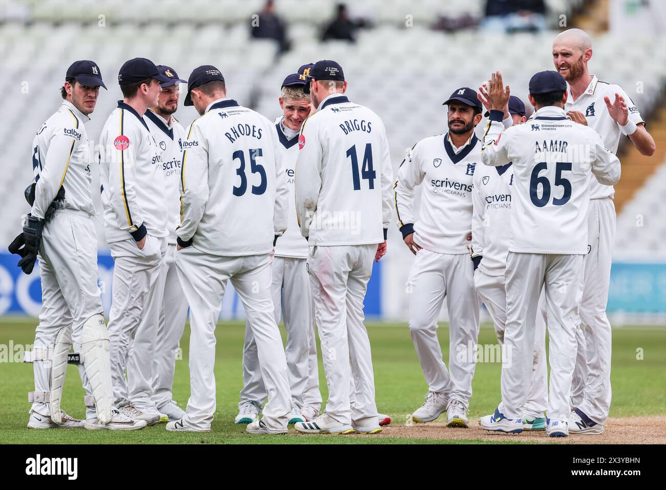 High fives for Olly Hannon-Dalby of Warwickshire (right facing camera ...