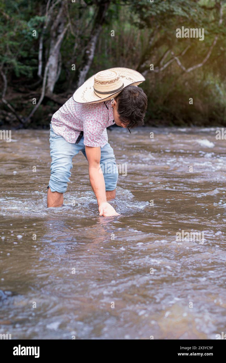 lifestyle. native man dips his hand in river water Stock Photo