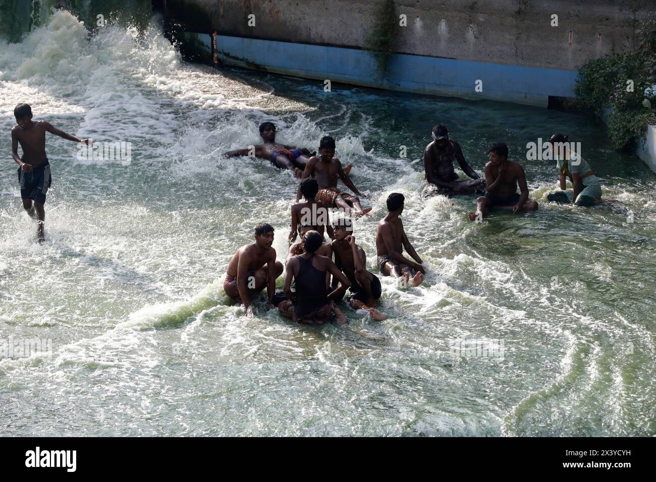 Dhaka, Bangladesh - April 29, 2024: People of all ages are enjoying water sports in Hatirjheel of the Dhaka for a little relief from the scorching hea Stock Photo