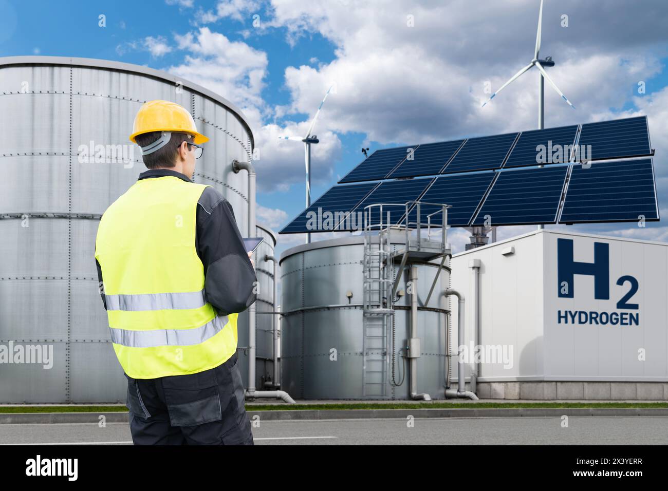 Engineer with tablet computer on a background of Hydrogen factory Stock Photo