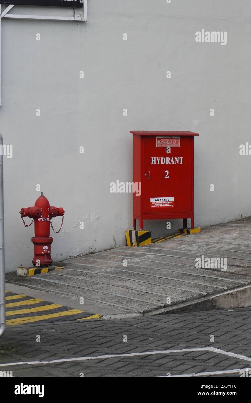Fire extinguisher box located outside the room Stock Photo