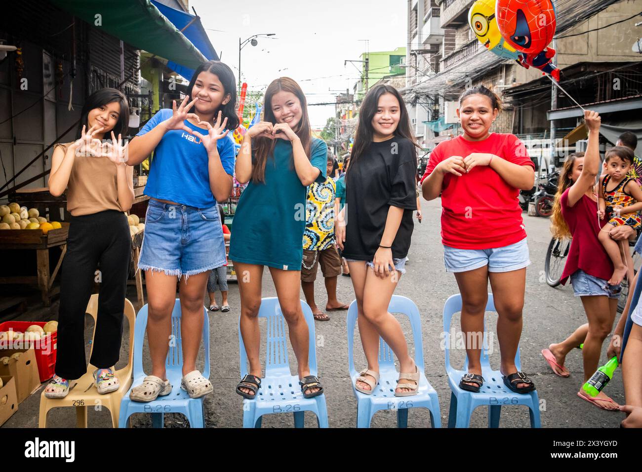 Filipino children play street games together during an annual religious
