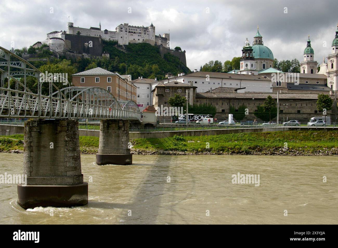 Mozartsteg bridge over The River Salzach. Featured in The Sound of Music movie. Saltzburg Castle behind. Stock Photo