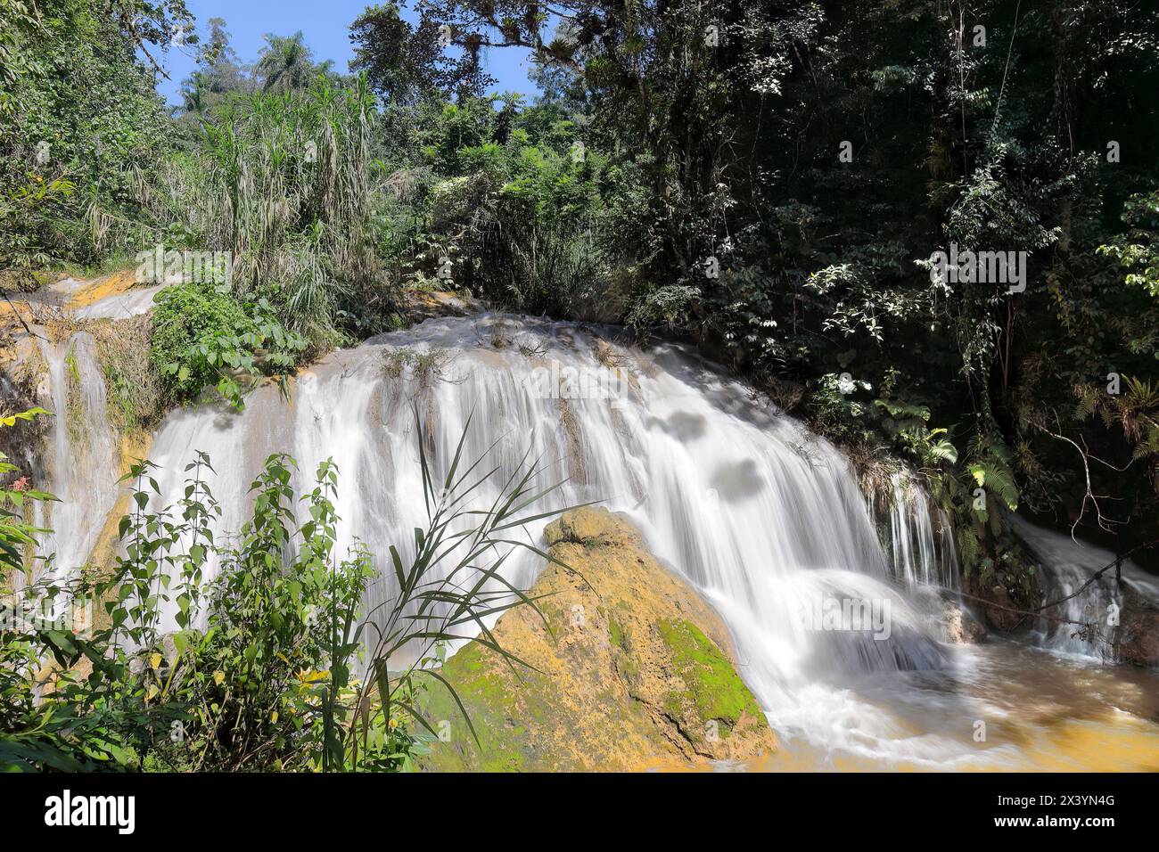 220 Waterfall of the Rio Melodioso River that forms the Poza el Venado Pool swimming spot on the Centinelas Hike, Guanayara Park. Cienfuegos-Cuba. Stock Photo