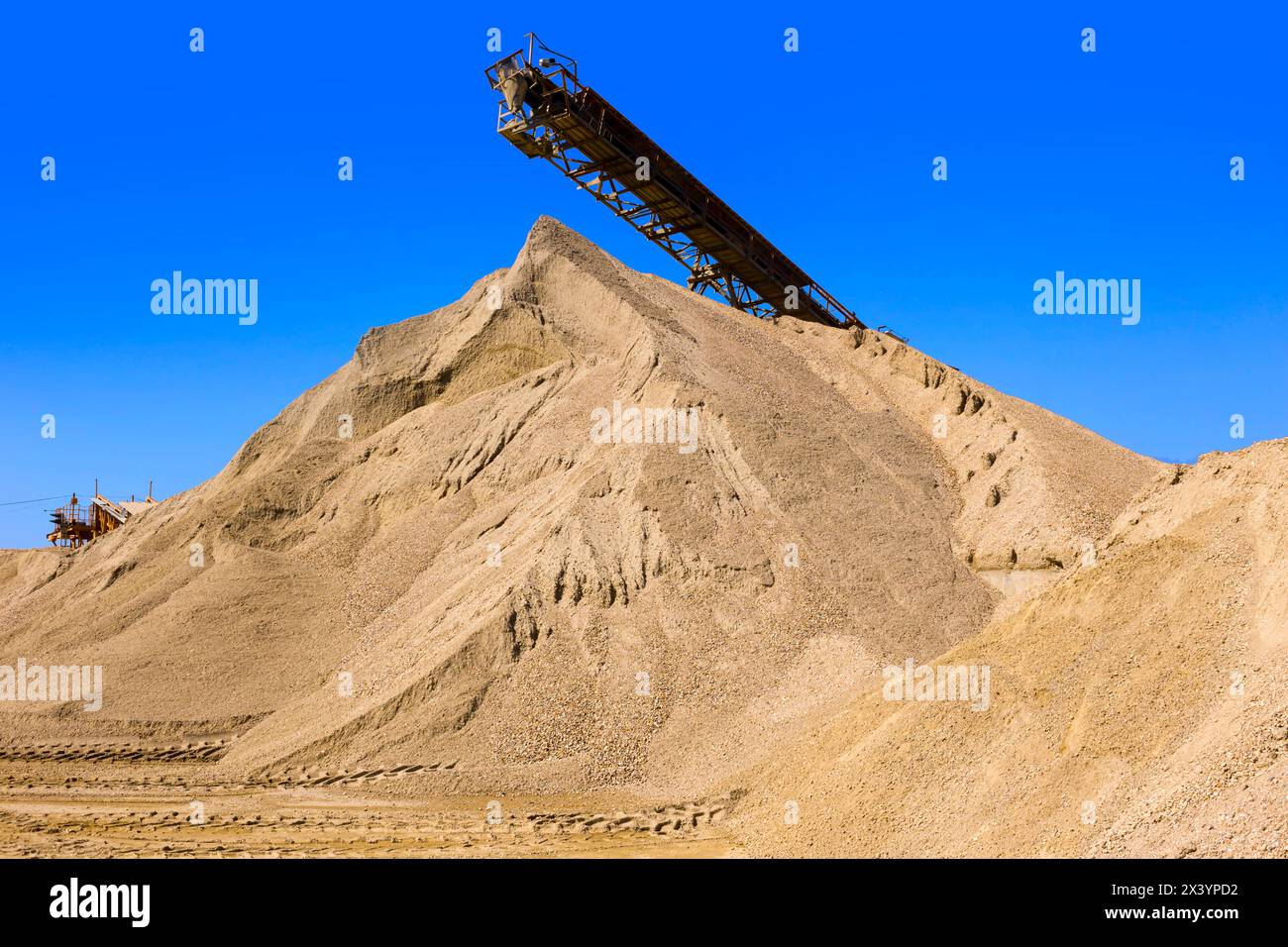 Conveyor belt in the gravel mine, gravel sand mountain is the raw ...