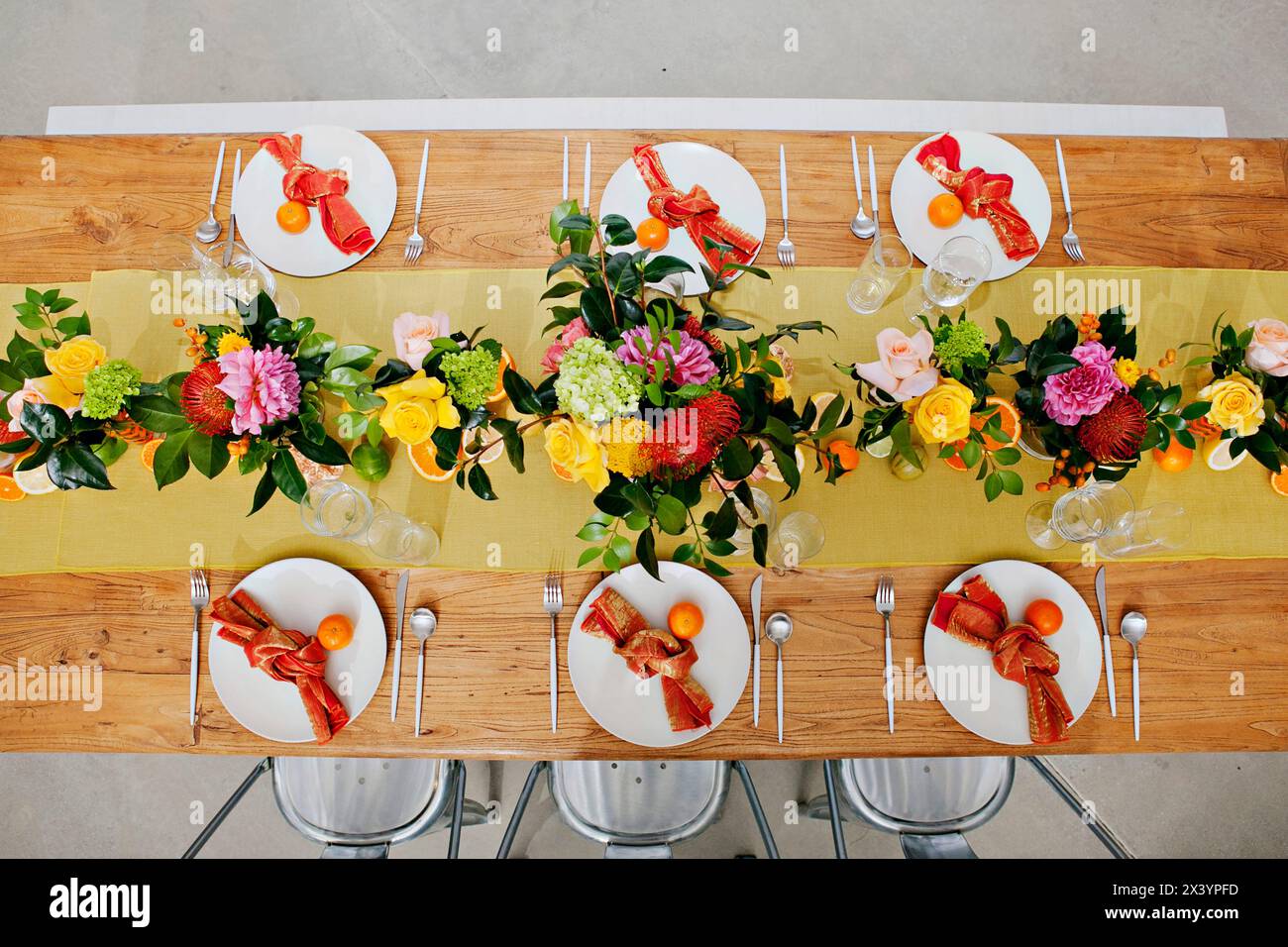 Lively table setting with floral and citrus elements. Stock Photo