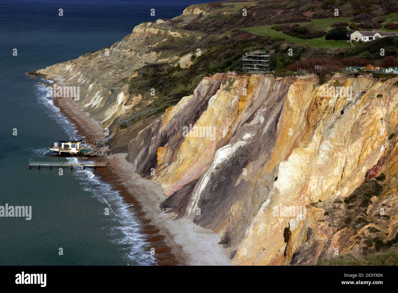 The multi-coloured sand cliffs of Alum Bay are a geological curiosity and tourist attraction on the west coast of the Isle of Wight, near the Needles. Stock Photo