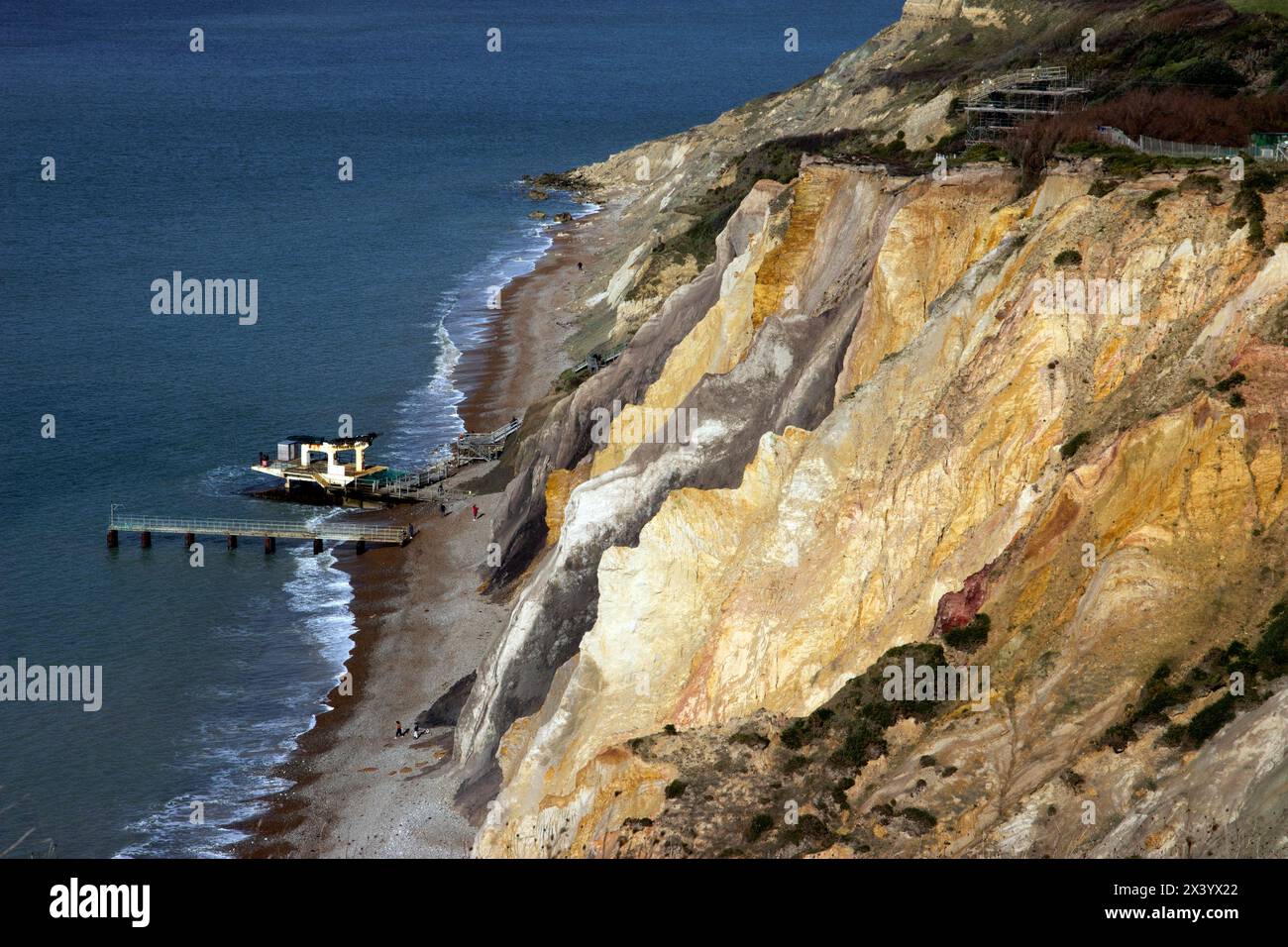 The multi-coloured sand cliffs of Alum Bay are a geological curiosity and tourist attraction on the west coast of the Isle of Wight, near the Needles. Stock Photo