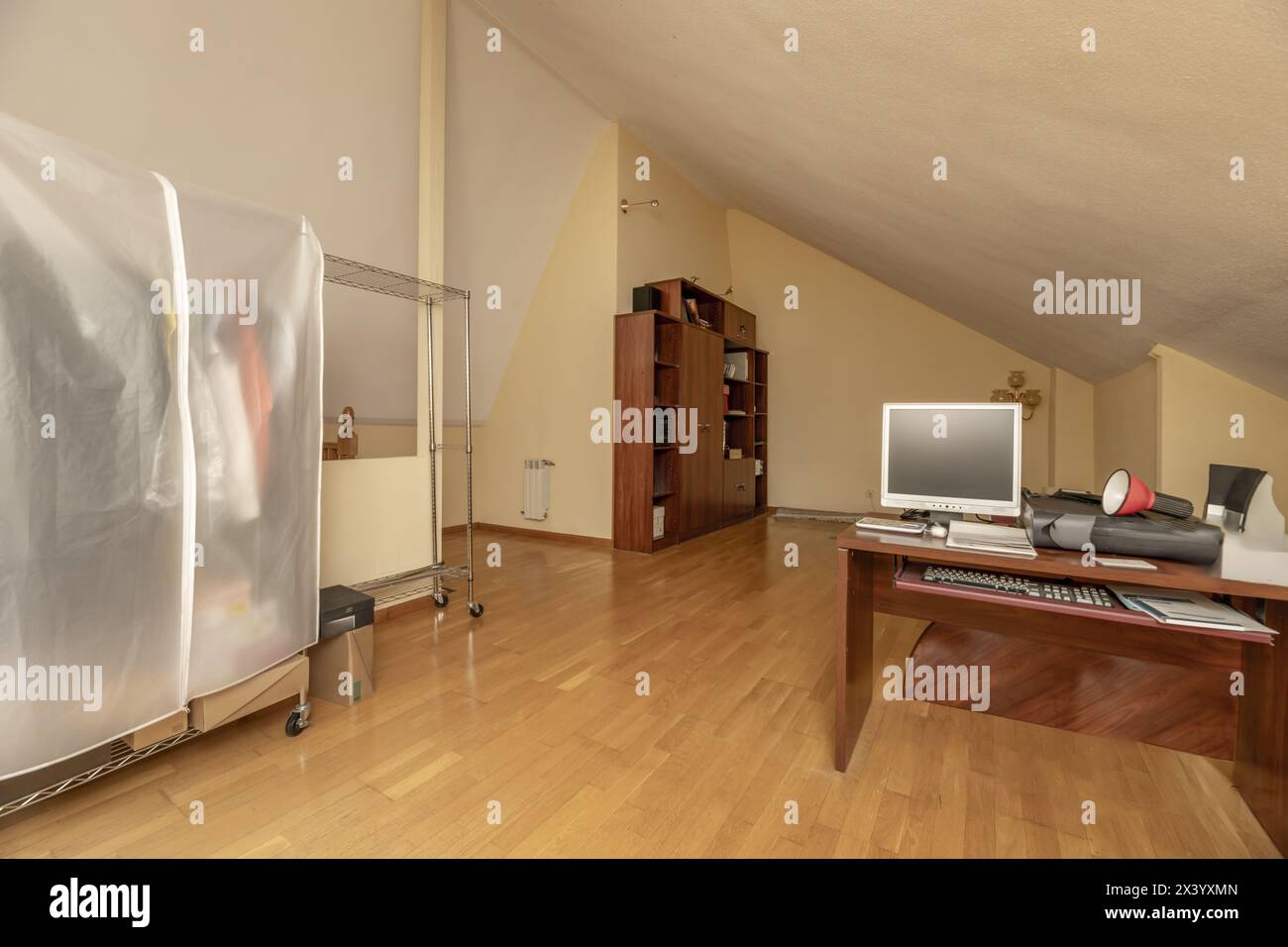 Large office in an attic room with large windows with skylights, white ...