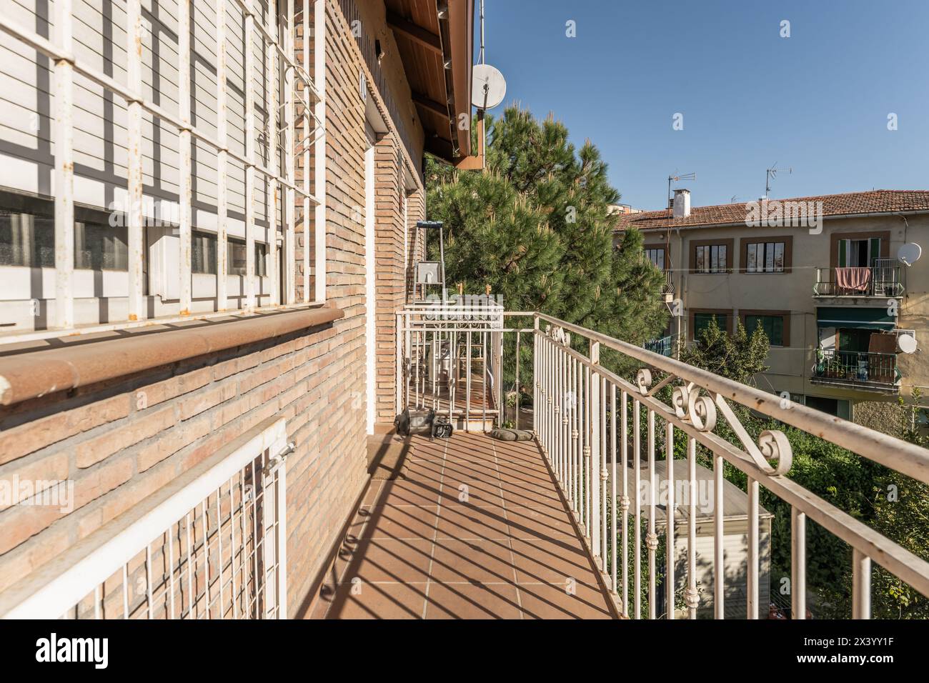 View of Narrow terraces of apartment building with terracotta stairs with white ...