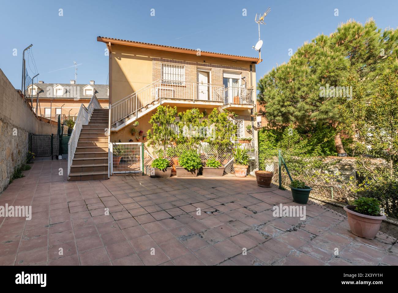 Image showcasing Facade of an apartment building with terracotta stairs with white metal ...