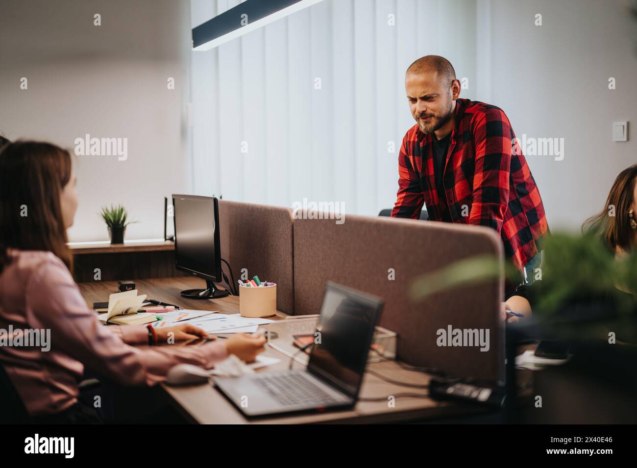 Business teamwork in a modern office: Workers engaging in a collaborative project Stock Photo