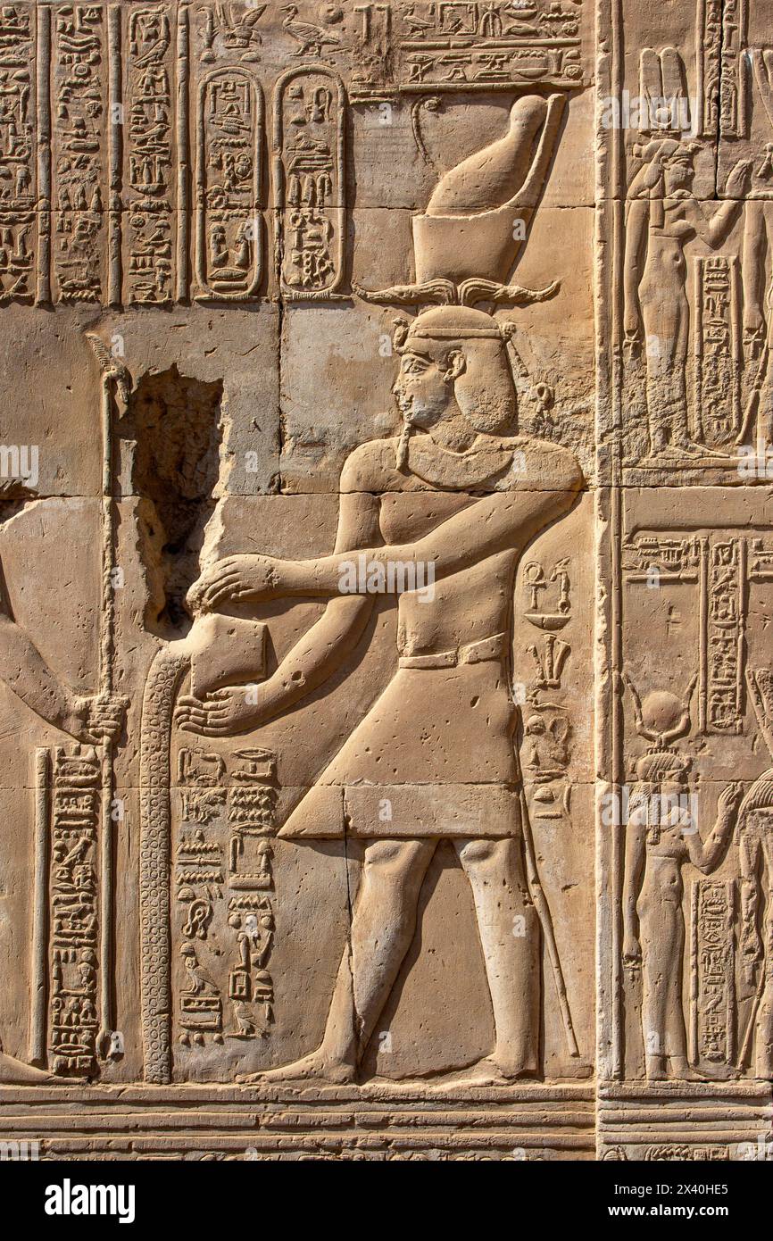 Bas-relief of a Greek king of the Ptolemaic dynasty making an offering at he Temple of Kom Ombo, Egypt Stock Photo