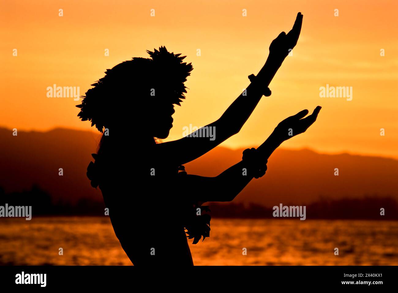 Silhouette of a traditional dancer in the Hawaiian Islands at sunset; Oahu, Hawaii, United States of America Stock Photo