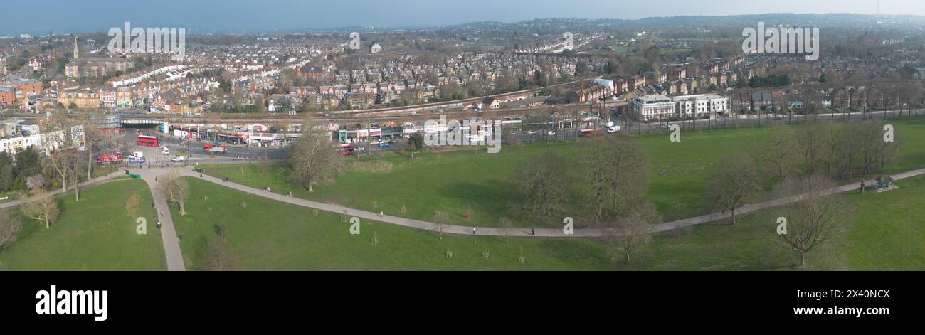 London- Aerial view of London skyline showing train leaving Herne Hill Station and city and residential buildings in background Stock Photo