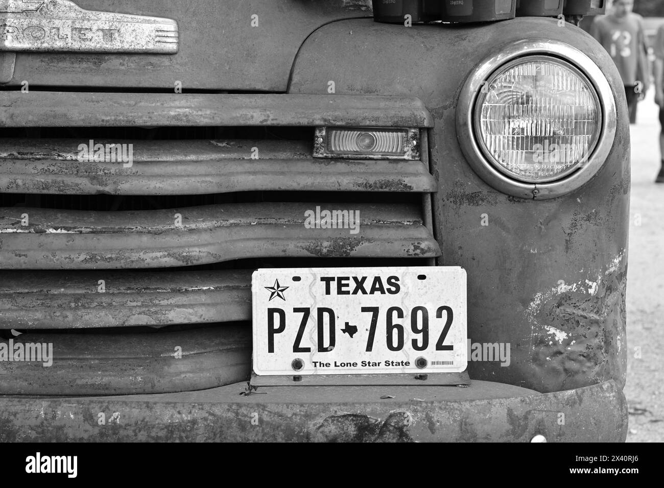 Vintage Chevrolet Pickup front grill with Texas tags in Black & White Stock Photo