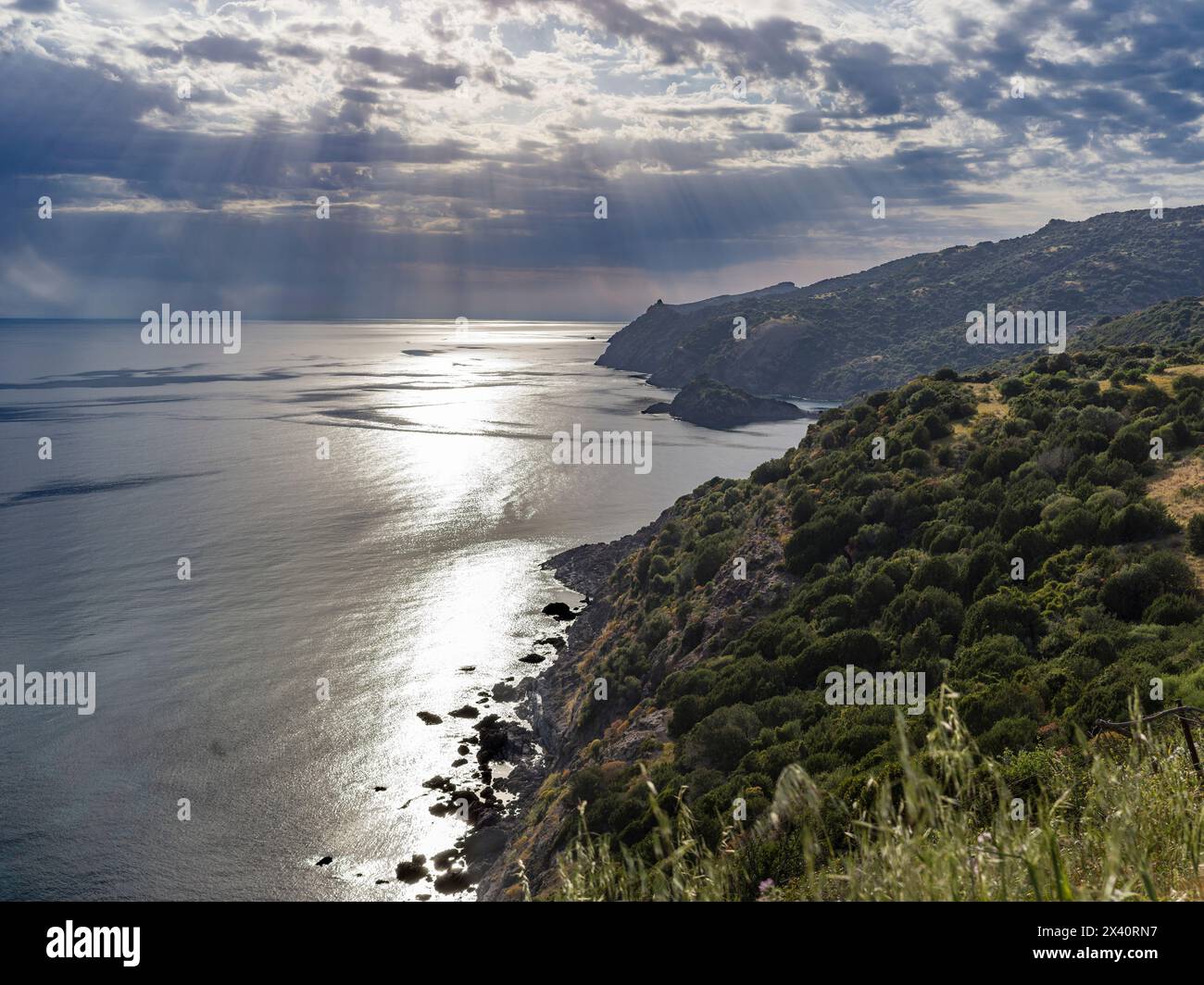 Sun rays stream over the Mediterranean Sea and coastline after a storm ...