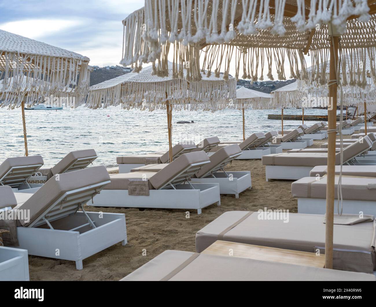 Luxurious beach chairs and umbrellas on a beach in the mediterranean; Mykonos, South Aegean, Greece Stock Photo