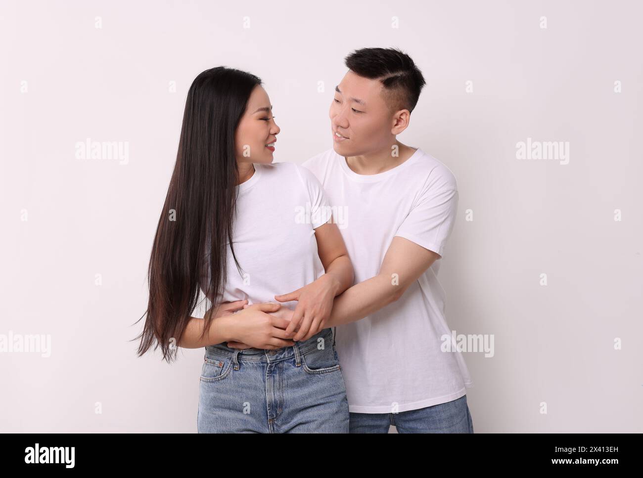 Portrait of happy couple on white background Stock Photo - Alamy