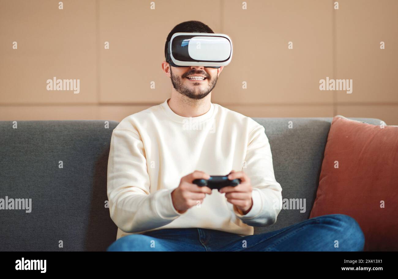 Young Man Engages in Virtual Reality Gaming at Home Stock Photo