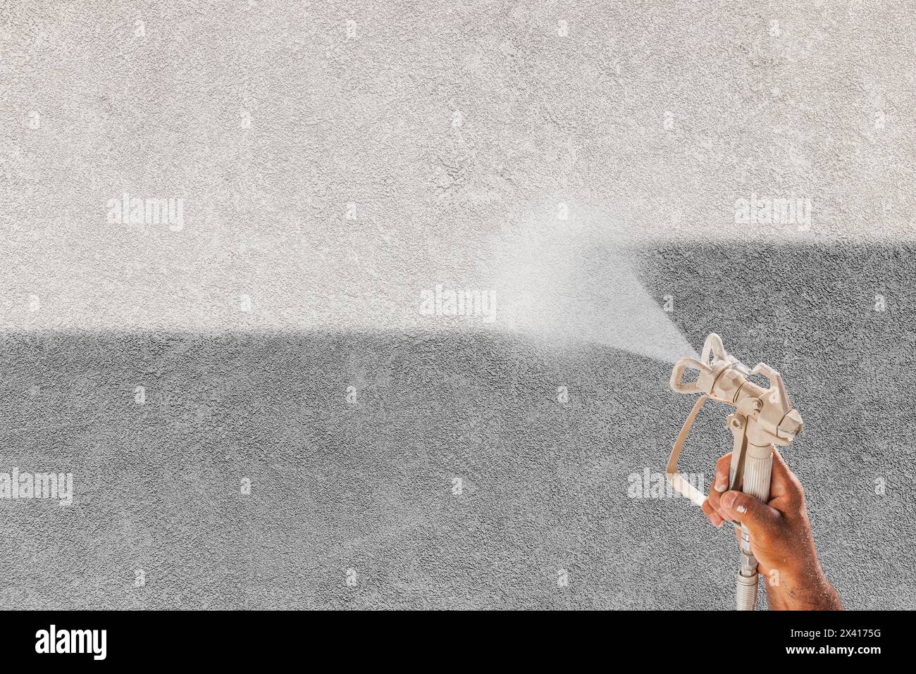 Professional Spray Painter Holding Spray Gun Spraying White Paint Over