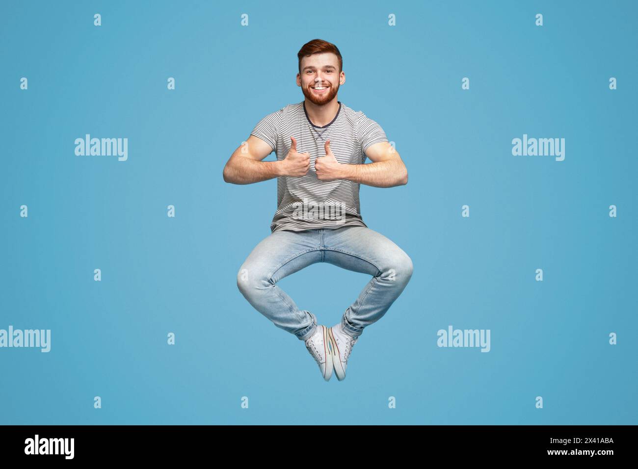 Joyful man jumping up in air, demonstrating thumbs up gesture Stock ...