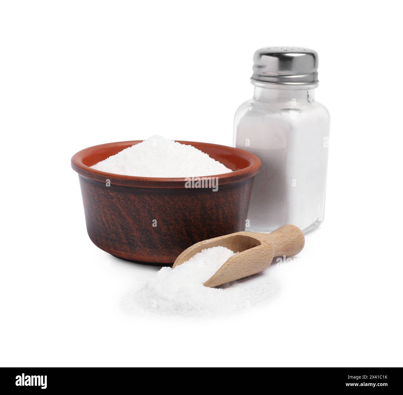 Natural salt in shaker, bowl and scoop isolated on white Stock Photo