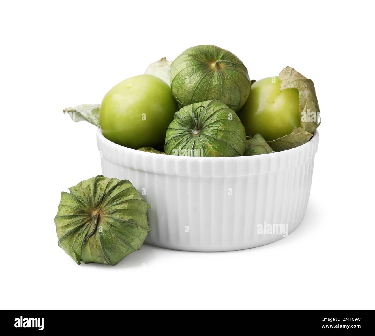 Bowl of fresh green tomatillos with husk isolated on white Stock Photo