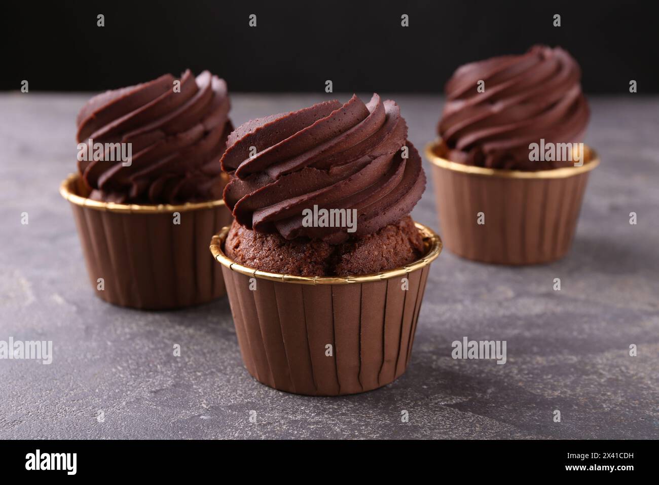 Delicious chocolate cupcakes on grey table, closeup Stock Photo