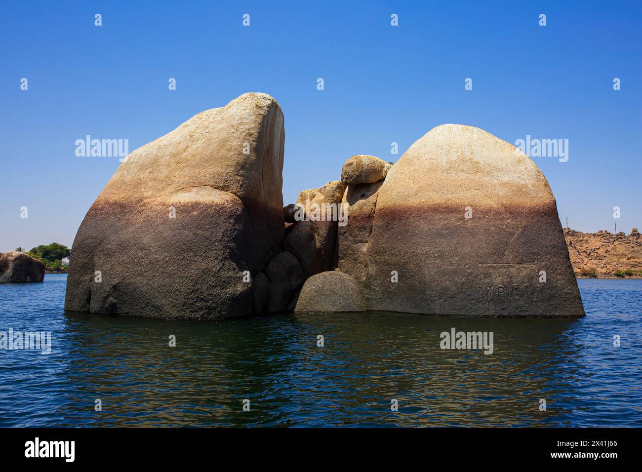Partially submerged rock with pharaonic carvings in the Nile just ...