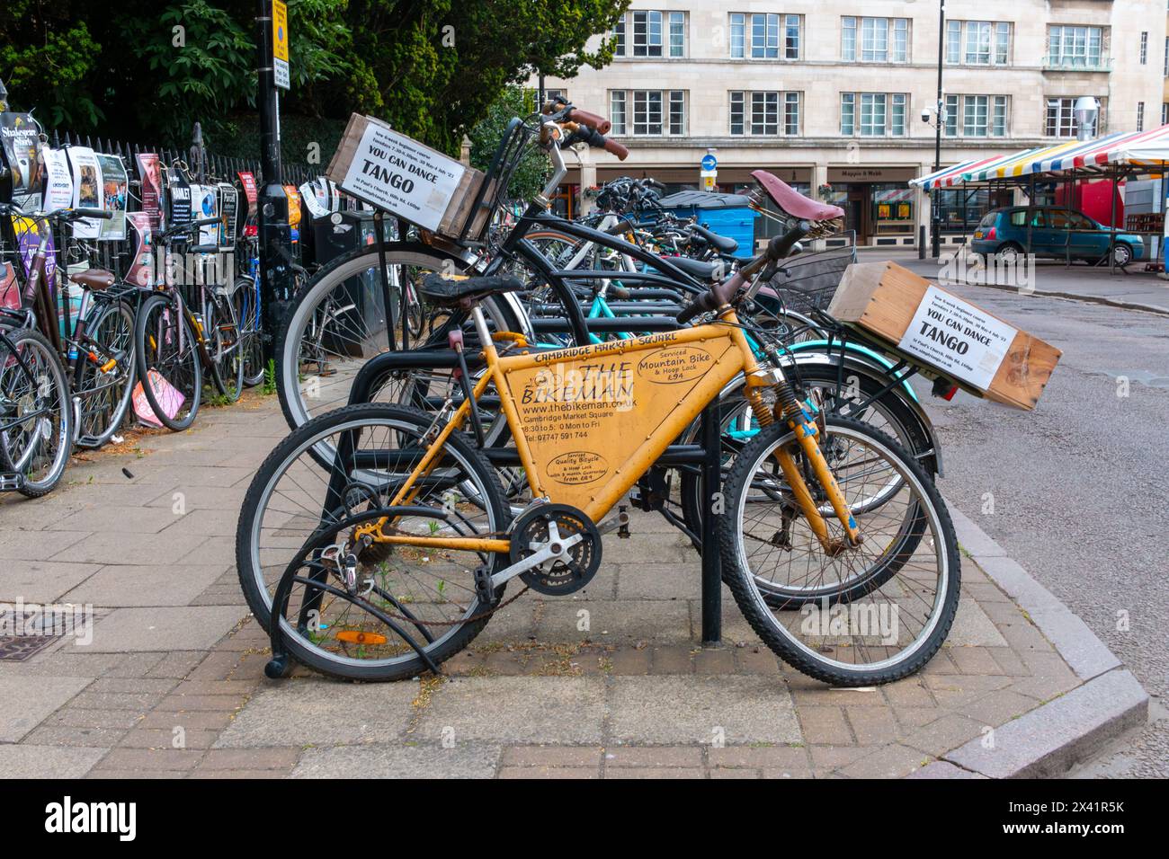 Bicycle advertising The Bikeman, bike repair parked next to bikes