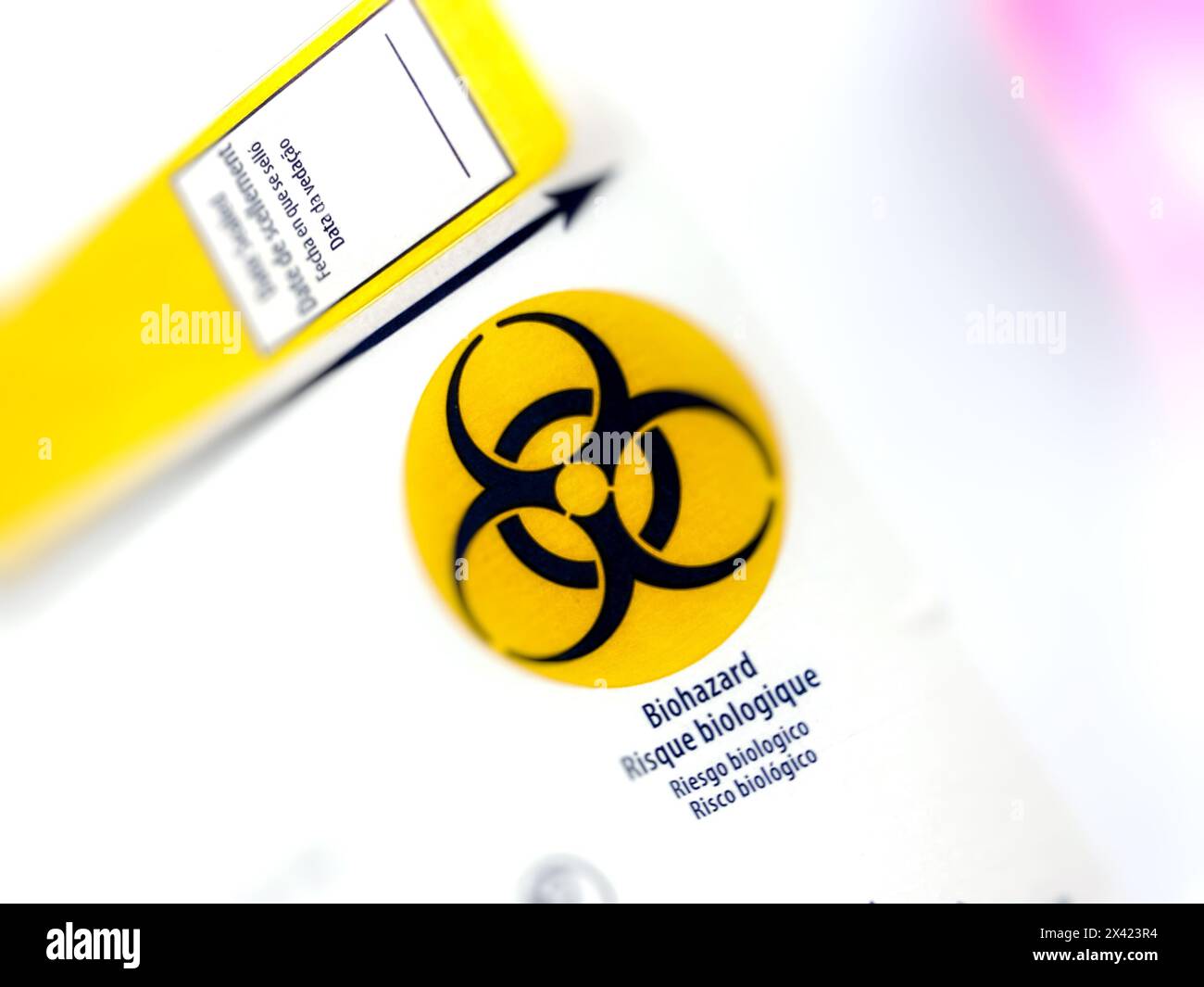 Biohazard symbol, black and yellow biohazard sign on a medical sharps ...