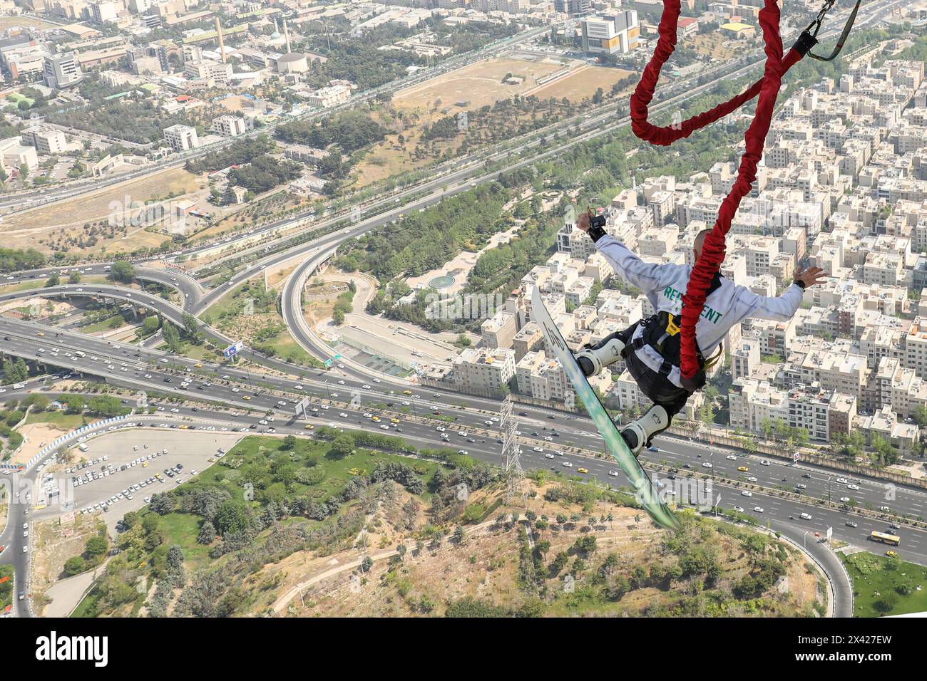 Tehran, Tehran, Iran. 29th Apr, 2024. An Iranian man jumps with his skiboard from the 280-meter-high bungee jumping platform at the Milad tower in Tehran, Iran, on 29 April 2024. According to Amir Badri, the head of the Gmax entertainment department manager, the platform was inaugurated at the Milad Tower on 29 April 2024. (Credit Image: © Sobhan Farajvan/Pacific Press via ZUMA Press Wire) EDITORIAL USAGE ONLY! Not for Commercial USAGE! Credit: ZUMA Press, Inc./Alamy Live News Stock Photo