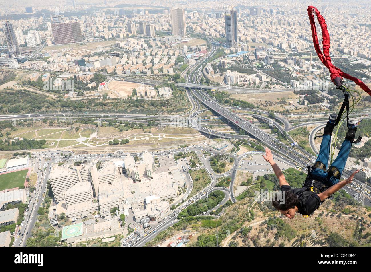 Tehran, Tehran, Iran. 29th Apr, 2024. Amir badri jumps from the 280-meter-high bungee jumping platform at the Milad tower in Tehran, Iran, on 29 April 2024. According to Amir Badri, the head of the Gmax entertainment department manager, the platform was inaugurated at the Milad Tower on 29 April 2024. (Credit Image: © Sobhan Farajvan/Pacific Press via ZUMA Press Wire) EDITORIAL USAGE ONLY! Not for Commercial USAGE! Credit: ZUMA Press, Inc./Alamy Live News Stock Photo