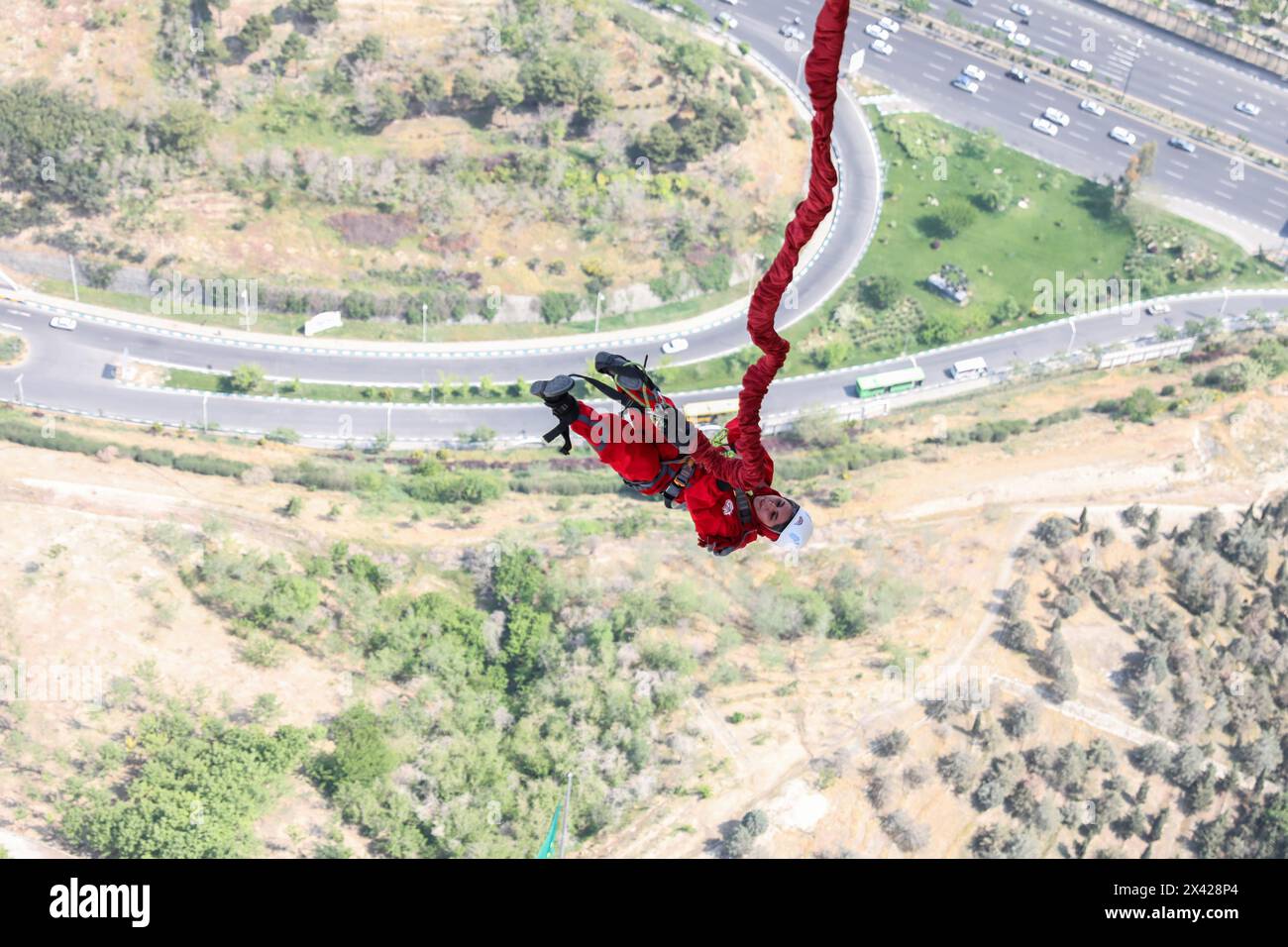 Tehran, Tehran, Iran. 29th Apr, 2024. An Iranian woman jumps from the 280-meter-high bungee jumping platform at the Milad tower in Tehran, Iran, on 29 April 2024. According to Amir Badri, the head of the Gmax entertainment department manager, the platform was inaugurated at the Milad Tower on 29 April 2024. (Credit Image: © Sobhan Farajvan/Pacific Press via ZUMA Press Wire) EDITORIAL USAGE ONLY! Not for Commercial USAGE! Credit: ZUMA Press, Inc./Alamy Live News Stock Photo