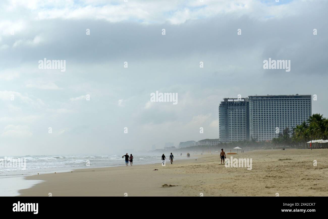 The beautiful long white sand beach along the changing waterfront skyline in Da Nang, Vietnam. Stock Photo