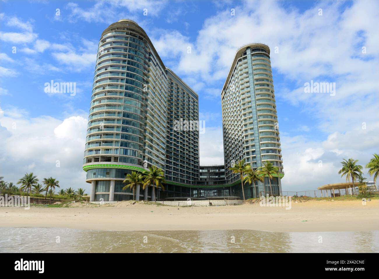 A new giant hotel under construction along the beautiful long white sand beach along the changing waterfront skyline in Da Nang, Vietnam. Stock Photo
