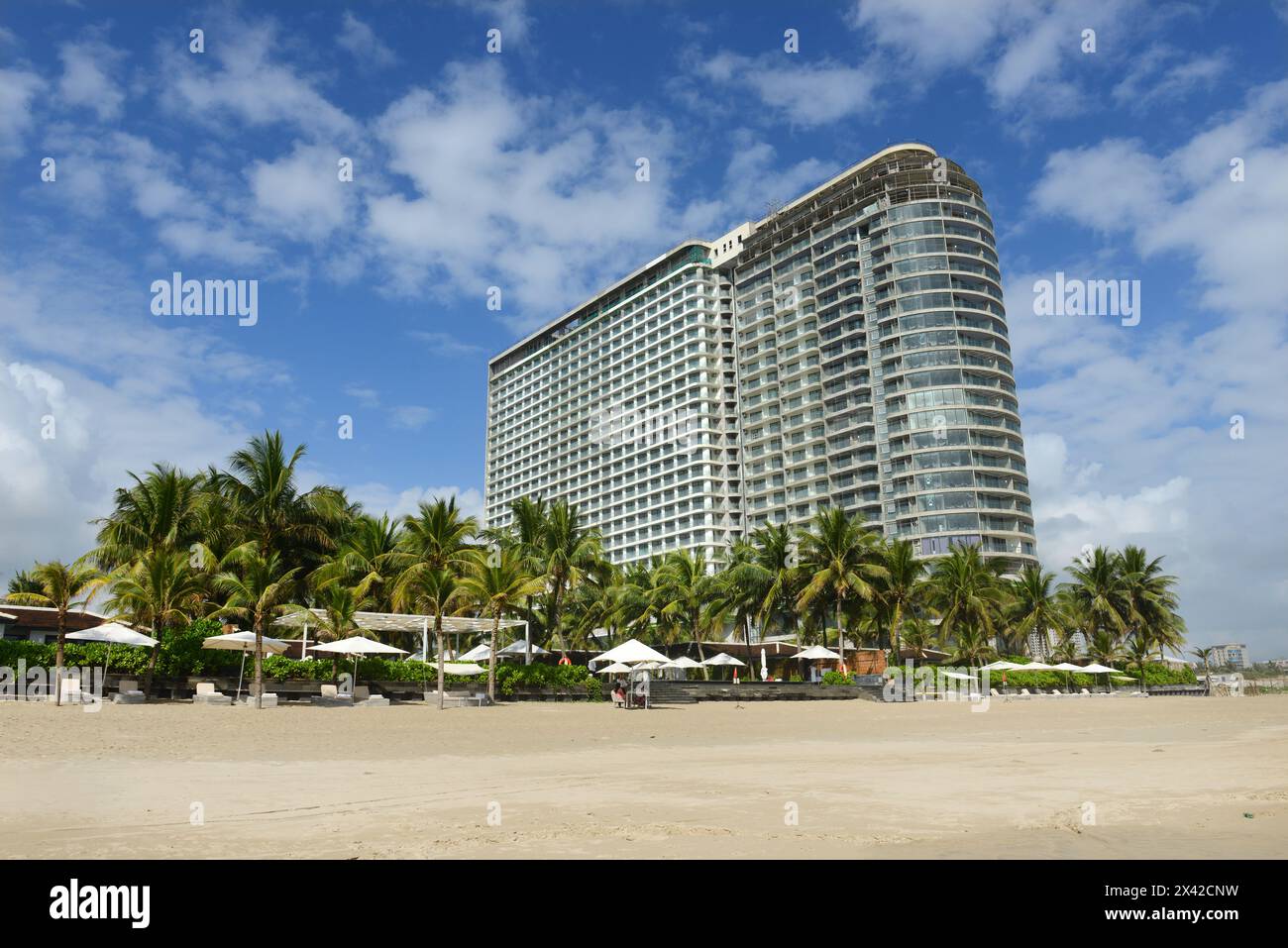 A new giant hotel under construction along the beautiful long white sand beach along the changing waterfront skyline in Da Nang, Vietnam. Stock Photo