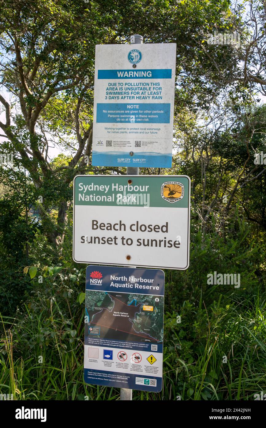 Collins Beach in Manly in Sydney Harbour national park, national park sign advises beach closed sunset to sunrise, NSW,Australia Stock Photo